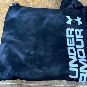 A black camouflage Under Armour Jacket. Size youth large.